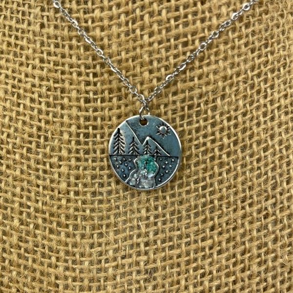pine tree necklace with river crystals in resin displayed on burlap