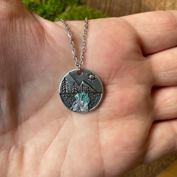 pine tree with river crystals in a palm of a hand