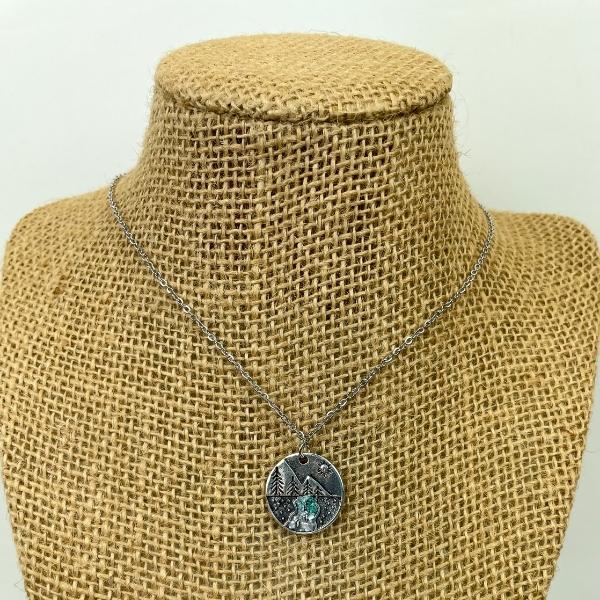 pine tree necklace with crystals in resin on a necklace stand