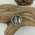wanderer pine tree necklace on a piece of wood