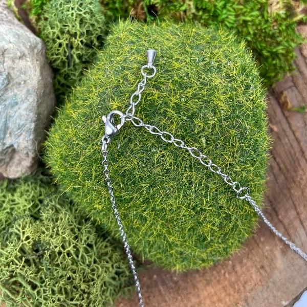 necklace clasp displayed on a piece of moss